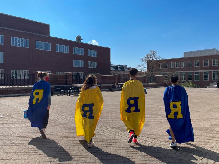 the back of 4 students wearing the letter "R"